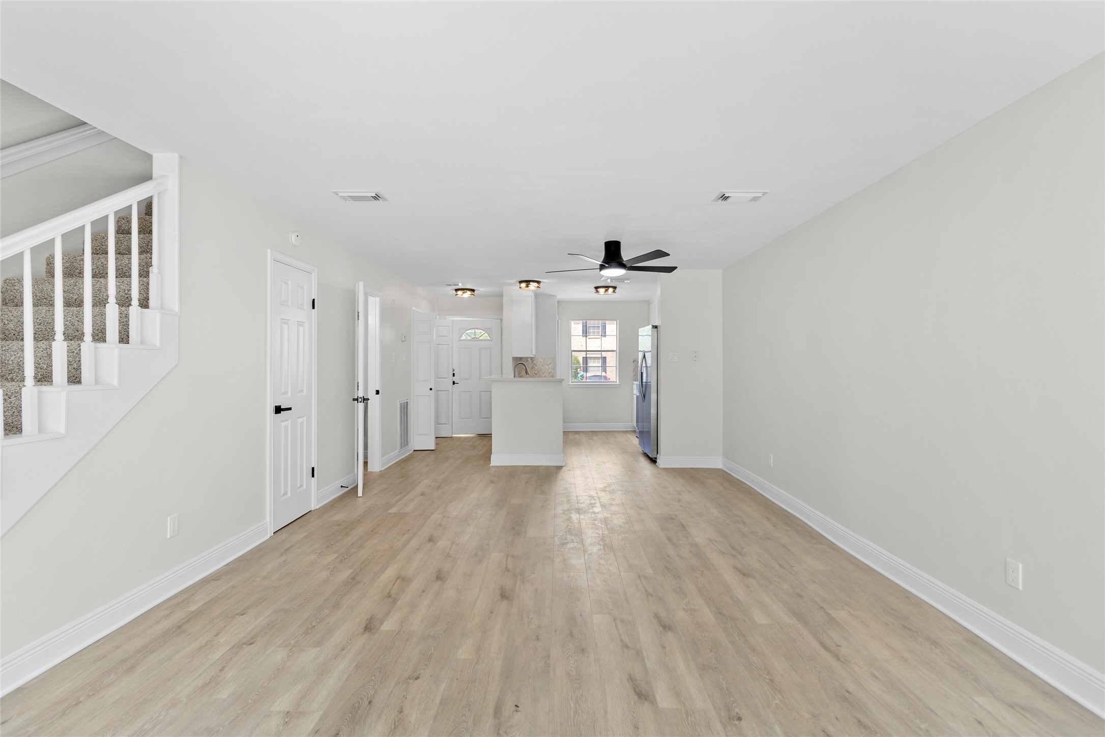 2030 Plantation Drive, Unit F3 Conroe, TX 77301 - Photo 6 of 22 a view of an empty room with wooden floor