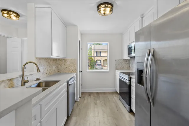 a kitchen with a refrigerator sink and stove