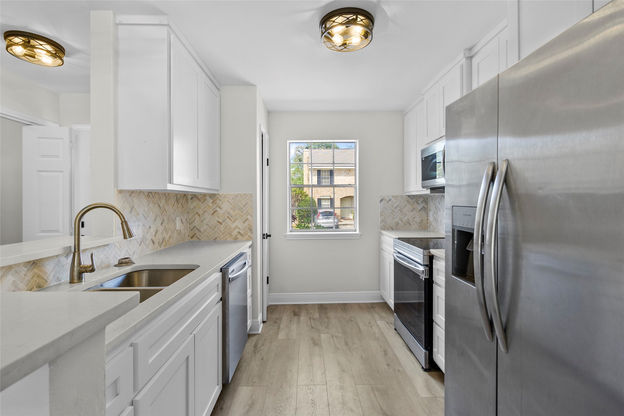 2030 Plantation Drive, Unit F3 Conroe, TX 77301 - Photo 8 of 22 a kitchen with a refrigerator sink and stove