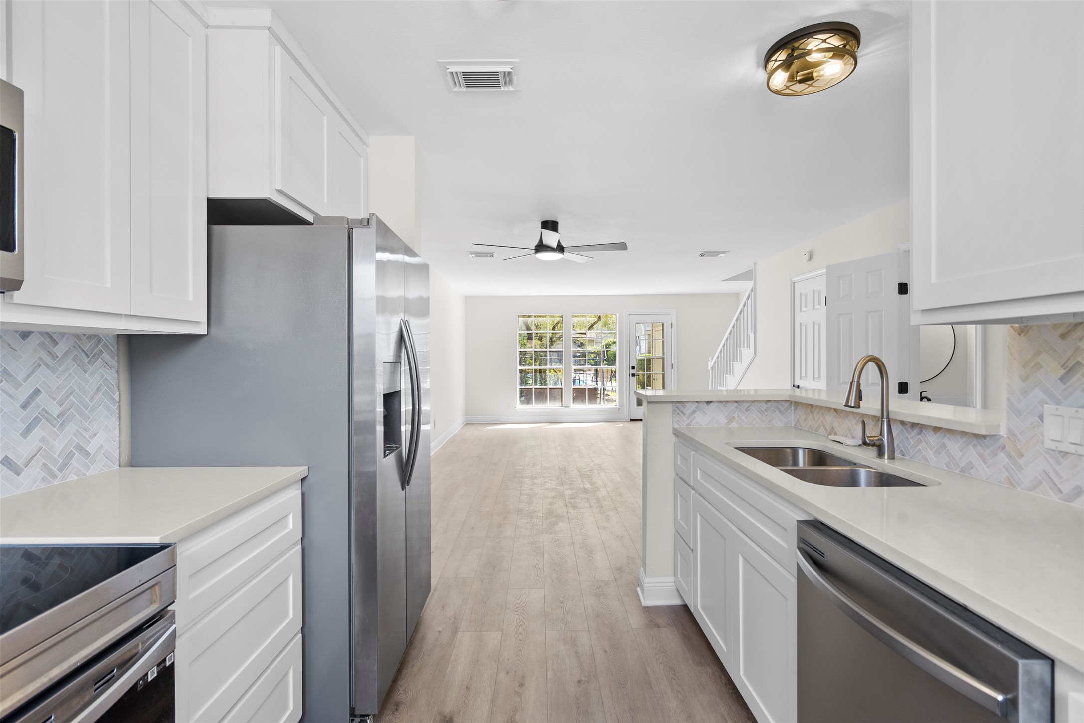 2030 Plantation Drive, Unit F3 Conroe, TX 77301 - Photo 9 of 22 a kitchen with stainless steel appliances granite countertop a sink stove and refrigerator