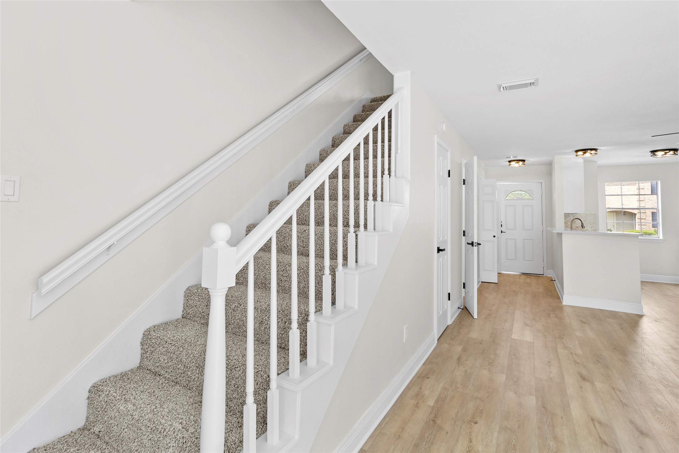 2030 Plantation Drive, Unit F3 Conroe, TX 77301 - Photo 10 of 22 a view of a hallway with wooden floor and staircase