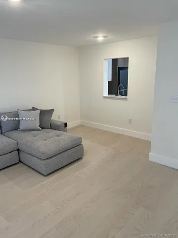 a living room with furniture and wall paintings