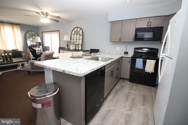a kitchen with a sink appliances and cabinets