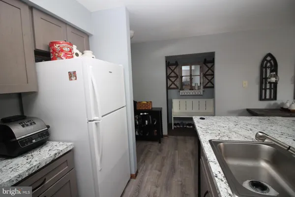 a kitchen with a refrigerator and a sink