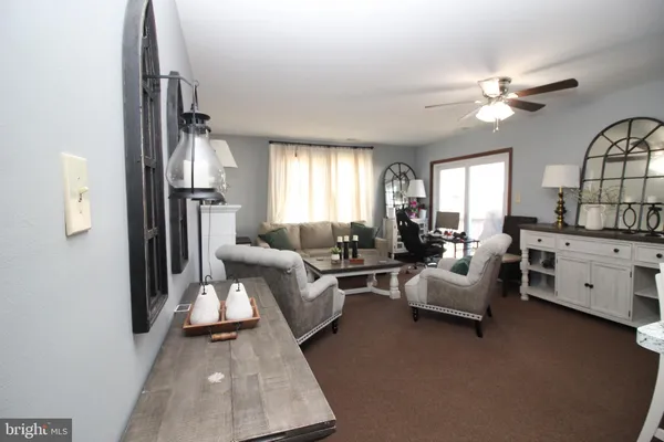 a living room with furniture and a chandelier