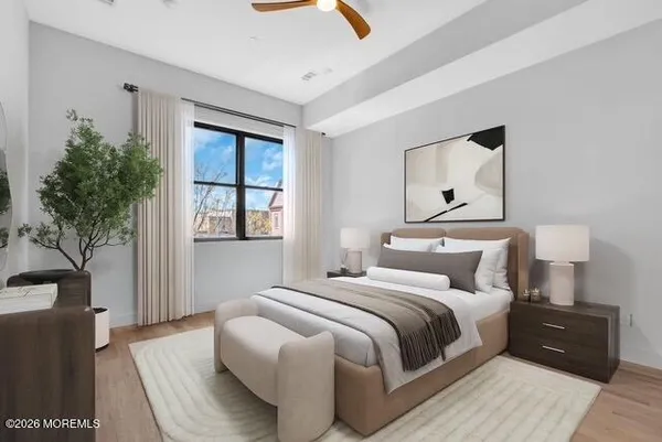 a bedroom with a bed lamp and a potted plant