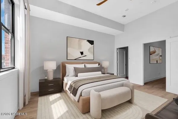 a bedroom with a bed and a painting on the wall