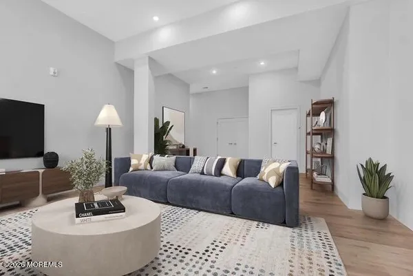 a living room with furniture and a potted plant