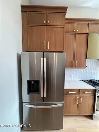 a kitchen with a refrigerator and a stove
