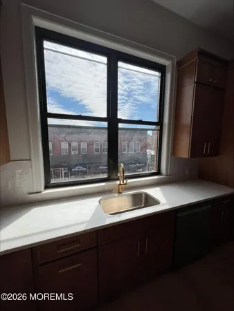a kitchen with a sink and large window