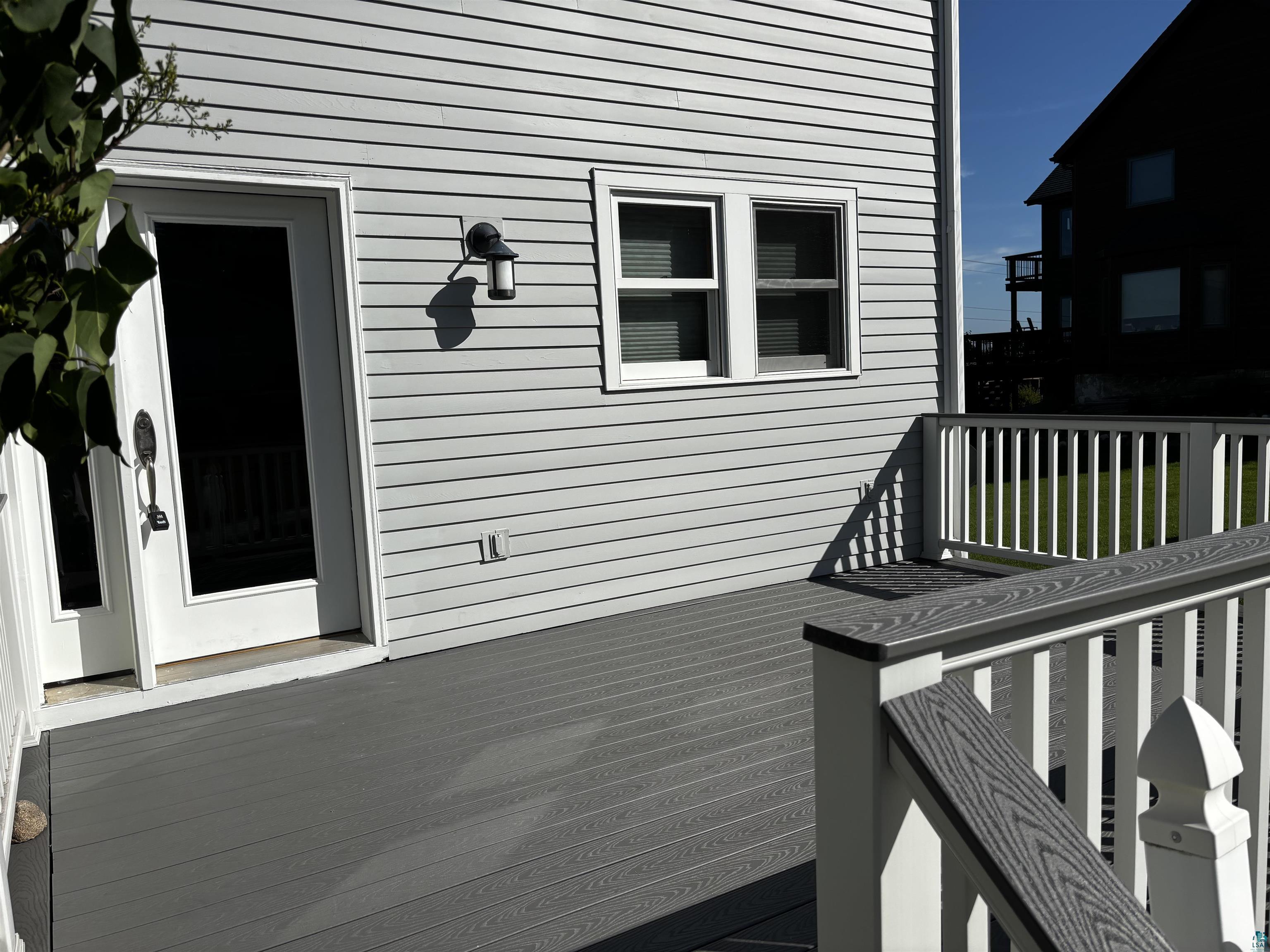13 West 8th Street Duluth, MN 55806 - Photo 52 of 57 Outdoor deck space featuring composite decking, white railing with composite top rail, and light gray horizontal siding