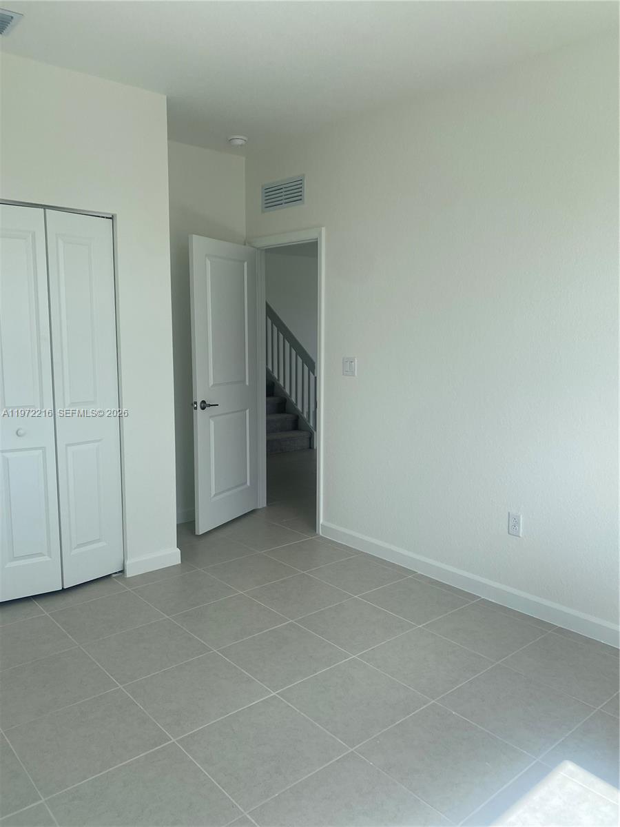 27441 Southwest 160th Avenue Homestead, FL 33031 - Photo 6 of 12 an empty room with a natural light