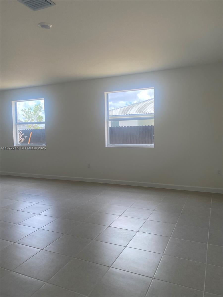 27441 Southwest 160th Avenue Homestead, FL 33031 - Photo 9 of 12 a view of an empty room with a window