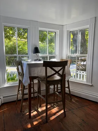 a dining room with furniture window wooden floor