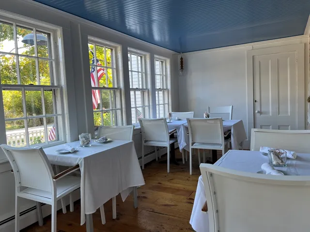a view of a dining room with furniture and window