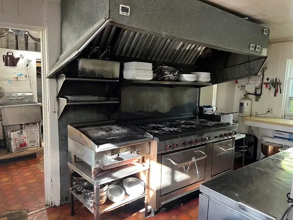 a stove top oven sitting inside of a kitchen