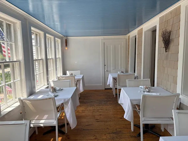 a view of a dining room with furniture and window