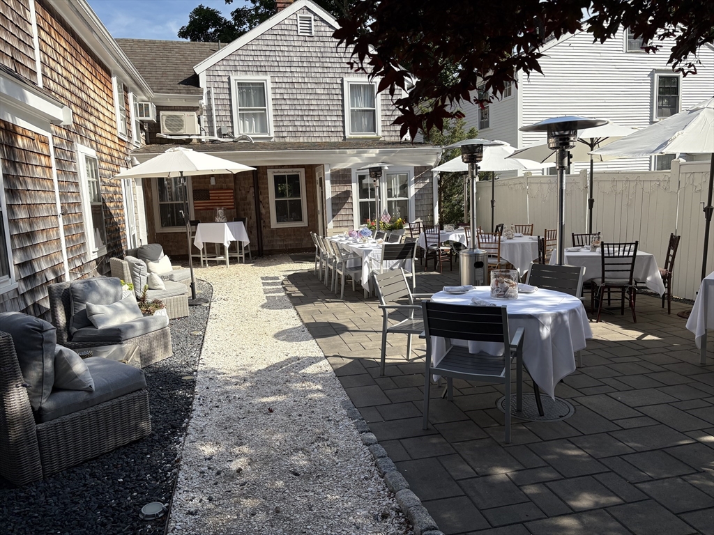 2019 Main Street Brewster, MA 02631 - Photo 6 of 17 a view of a patio with couches table and chairs and potted plants