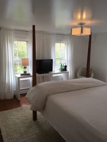 a bedroom with a bed and window