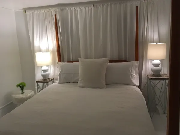 a bed room with a bed and a lamp