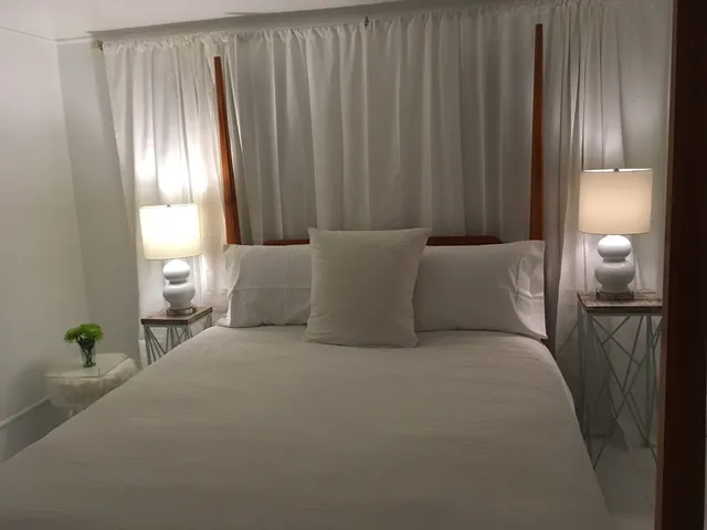 a bed room with a bed and a lamp