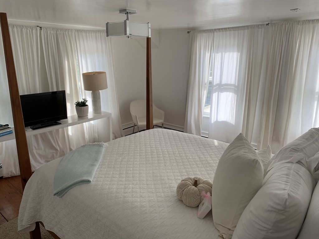 2019 Main Street Brewster, MA 02631 - Photo 10 of 17 a bedroom with a bed and large window