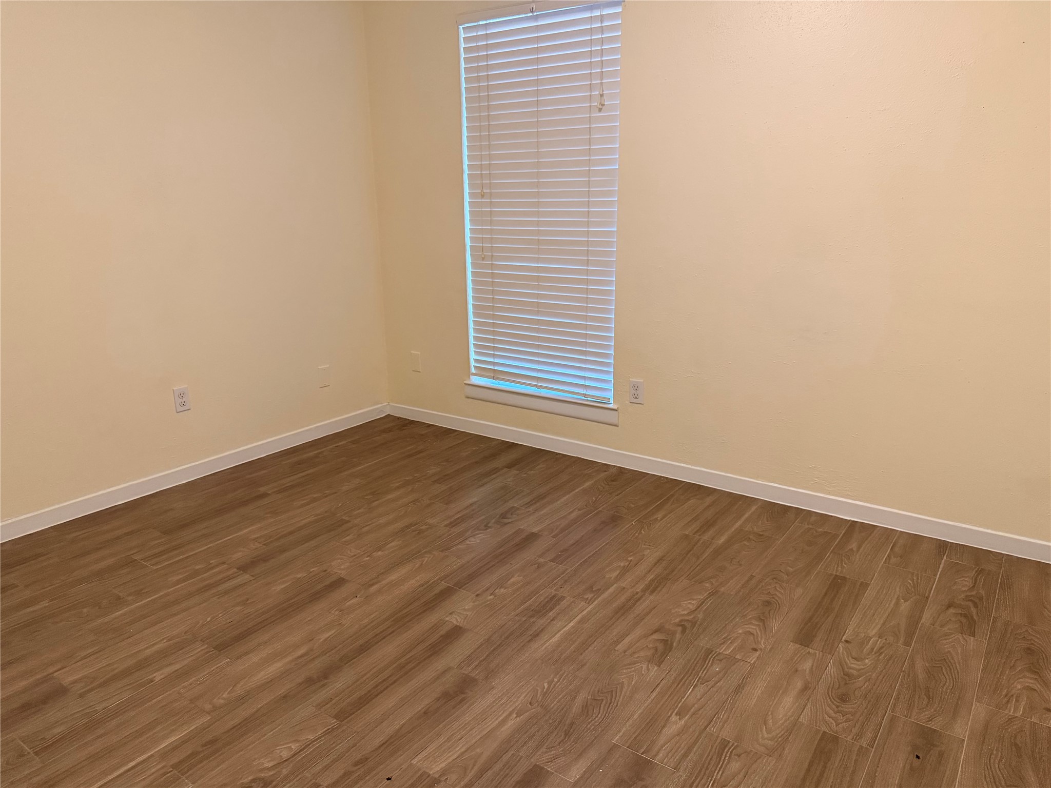 2439 Meandering Trail Houston, TX 77339 - Photo 6 of 8 an empty room with wooden floor and windows