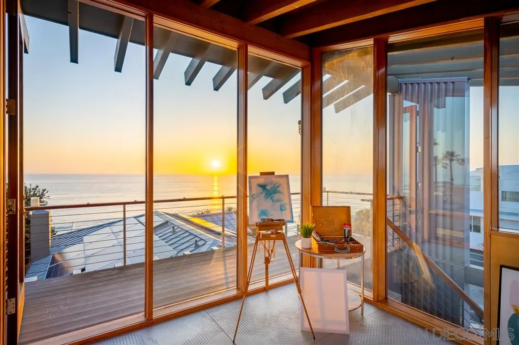 330 Neptune Avenue Encinitas, CA 92024 - Photo 11 of 13 a view of a living room with a floor to ceiling window and wooden floor