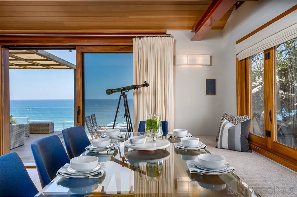 330 Neptune Avenue Encinitas, CA 92024 - Photo 7 of 13 a view of a dining room with furniture large windows and wooden floor