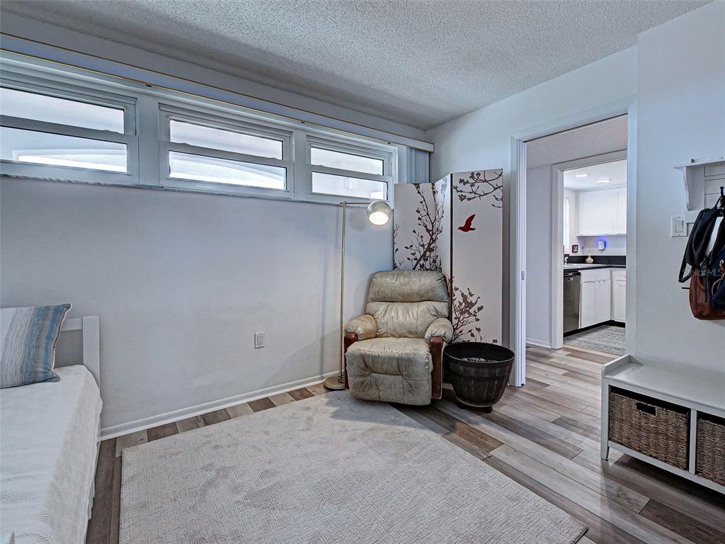 633 Alhambra Road, Unit 1006 Venice, FL 34285 - Photo 24 of 55 a living room with furniture and a flat screen tv
