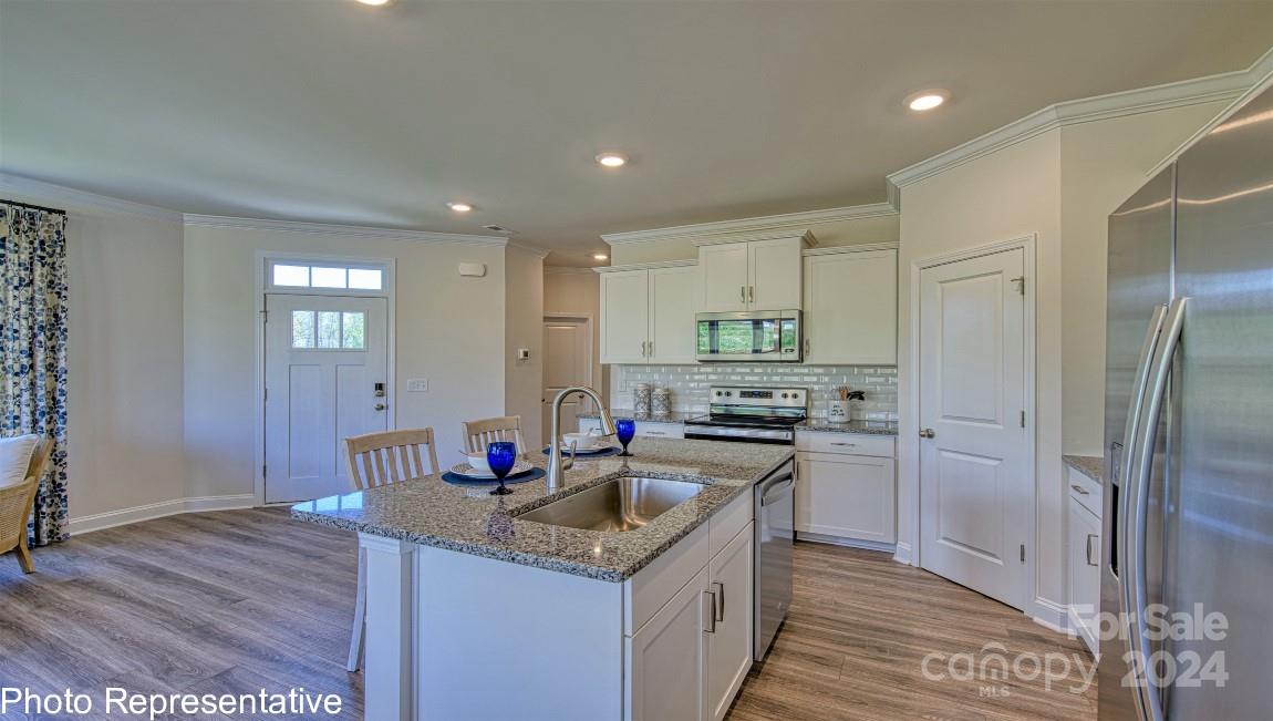 513 Wheatfield Road Fletcher, NC 28732 - Photo 6 of 47 a kitchen with stainless steel appliances granite countertop a sink stove and refrigerator