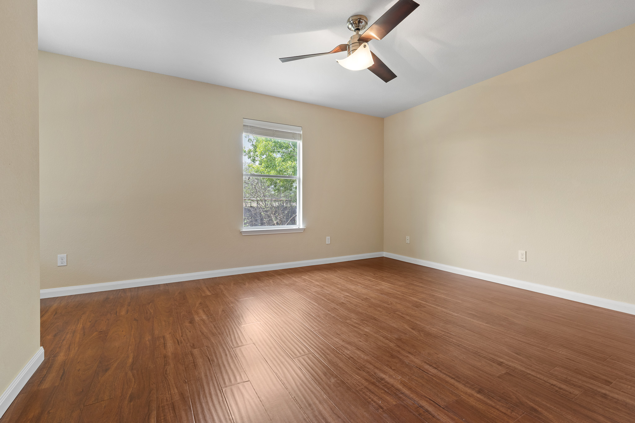 11400 Ashbrook Drive Manchaca, TX 78652 - Photo 13 of 32 an empty room with wooden floor fan and windows