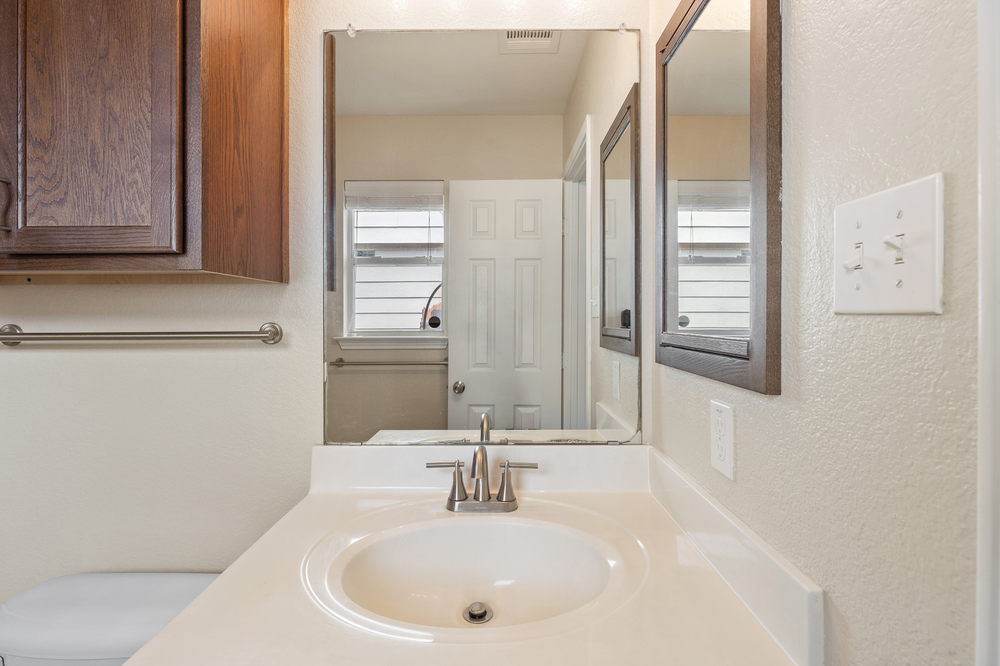11400 Ashbrook Drive Manchaca, TX 78652 - Photo 16 of 32 a bathroom with a sink and a mirror
