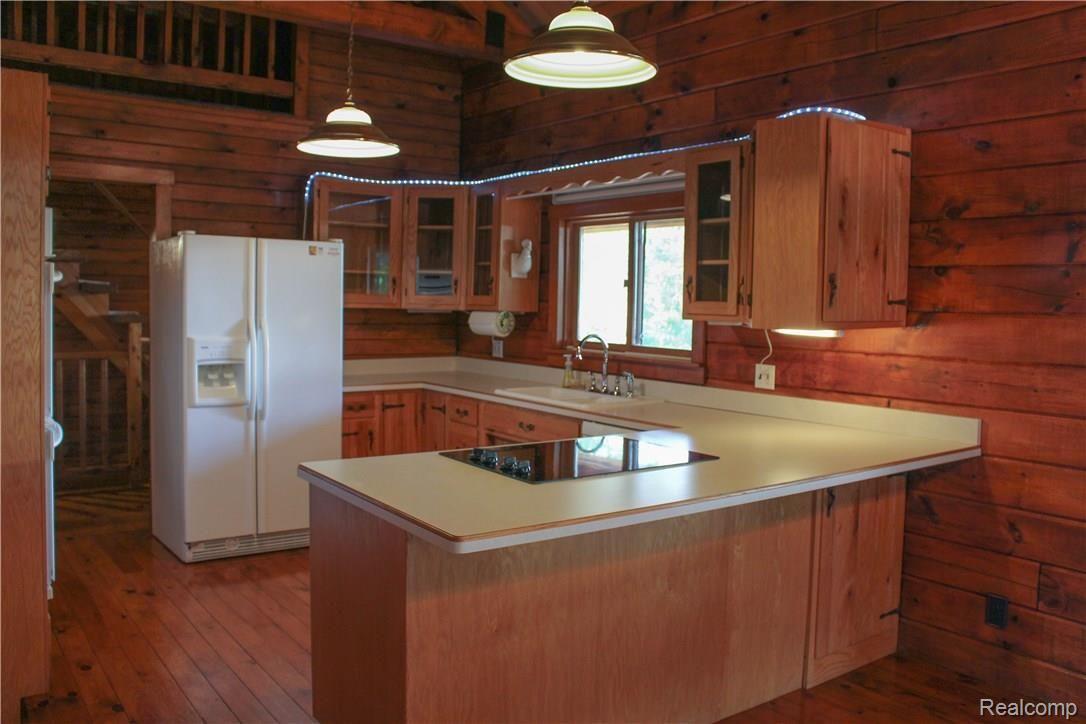 4165 Morgan Road Lake Orion, MI 48359 - Photo 33 of 81 Beautiful sparkling clean kitchen with natural wood cabinetry and lots of storage. Beautiful view from Kitchen window.