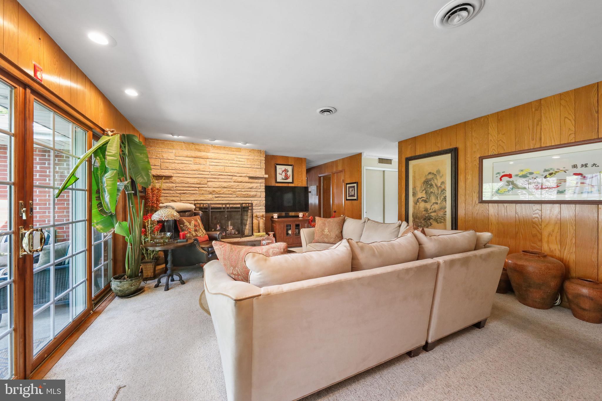 19 Diane Drive Ewing, NJ 08628 - Photo 20 of 38 a living room with furniture floor to ceiling window and a flat screen tv