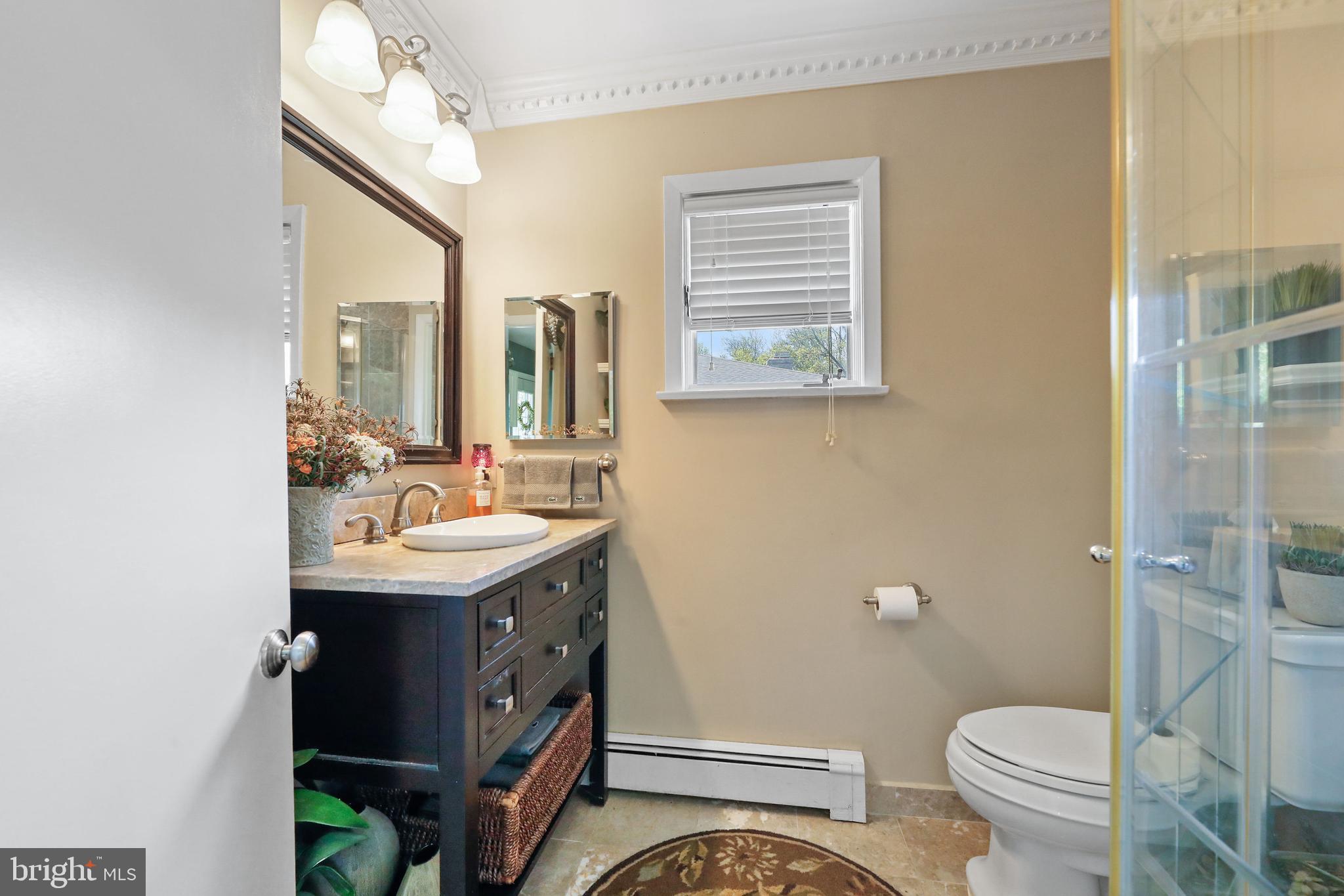 19 Diane Drive Ewing, NJ 08628 - Photo 23 of 38 a bathroom with a sink a toilet a mirror and shower