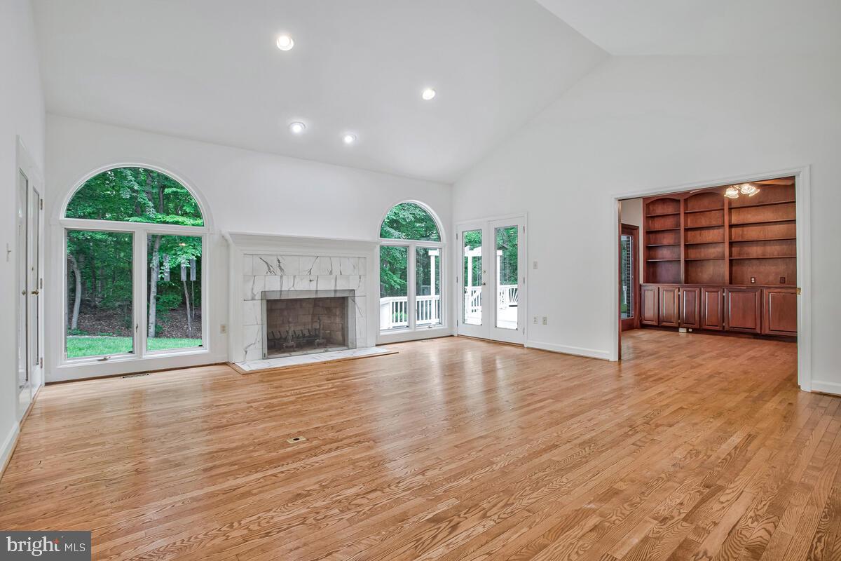 3170 Hickory Ridge Road Dunkirk, MD 20754 - Photo 22 of 74 an empty room with wooden floor a fireplace and windows