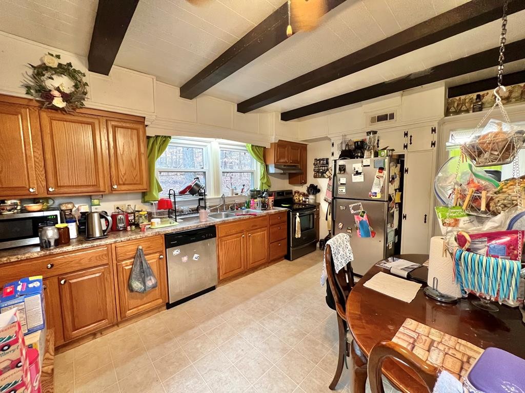 1380 Torbett Road Spring City, TN 37381 - Photo 8 of 30 a kitchen with stainless steel appliances kitchen island granite countertop a stove a sink dishwasher and cabinets with wooden floor