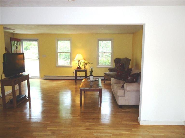 261 Simon Narrows Road Mashpee, MA 02649 - Photo 3 of 17 a living room with fireplace furniture and hard wood flooring
