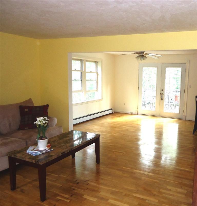 261 Simon Narrows Road Mashpee, MA 02649 - Photo 4 of 17 a living room with couches and a table with wooden floor