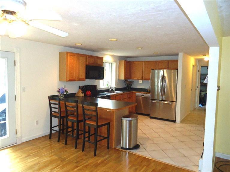 261 Simon Narrows Road Mashpee, MA 02649 - Photo 5 of 17 a kitchen with stainless steel appliances a refrigerator and a stove top oven
