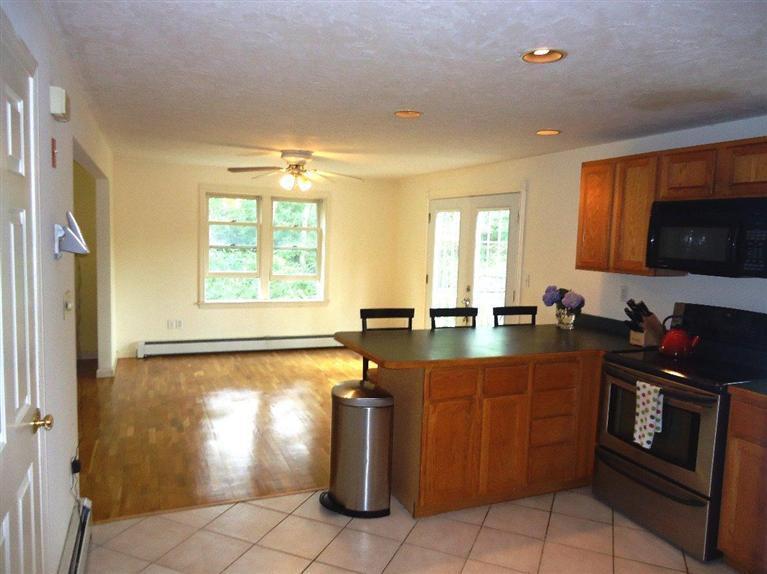 261 Simon Narrows Road Mashpee, MA 02649 - Photo 6 of 17 a kitchen with stainless steel appliances granite countertop a stove a sink and a microwave