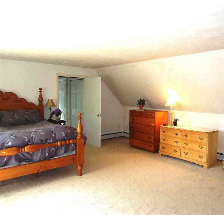 261 Simon Narrows Road Mashpee, MA 02649 - Photo 7 of 17 a bed room with furniture and a lamp