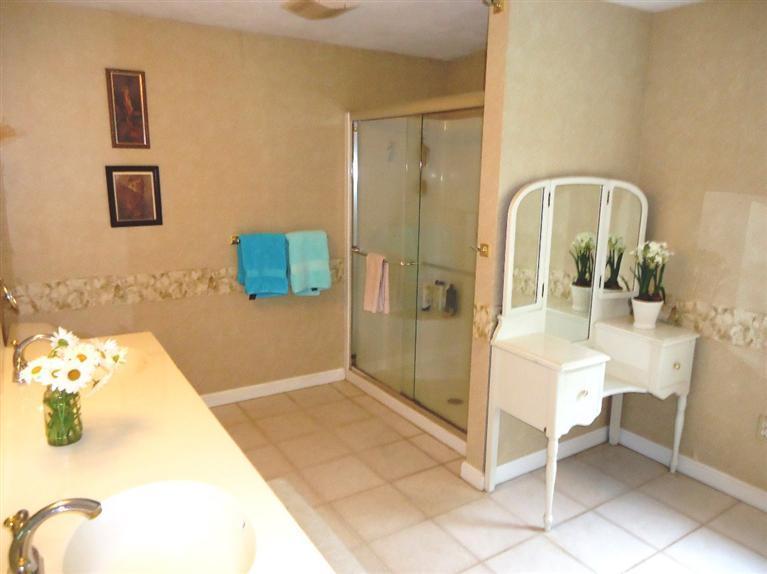 261 Simon Narrows Road Mashpee, MA 02649 - Photo 9 of 17 a bathroom with a tub sink and mirror
