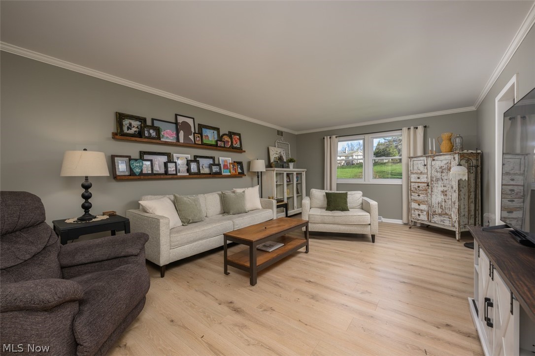 2108 Devonshire Road Northwest Canton, OH 44708 - Photo 7 of 33 Living room with double windows and vinyl flooring