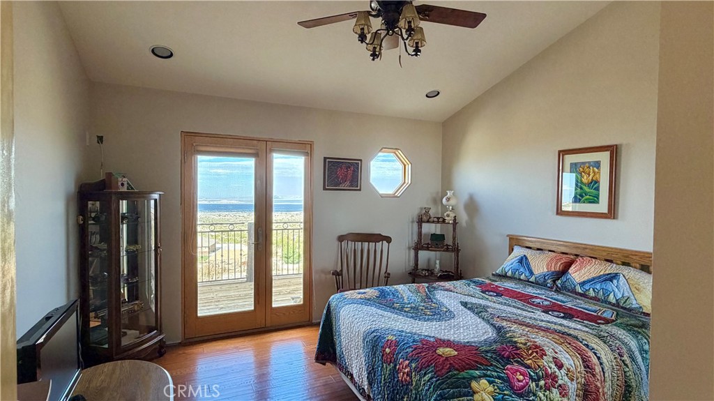 275 Canyon Road Pinon Hills, CA 92372 - Photo 28 of 68 a bedroom with bed and wooden floor