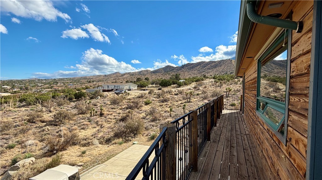 275 Canyon Road Pinon Hills, CA 92372 - Photo 50 of 68 a view of a balcony with wooden floor and a floor to ceiling window