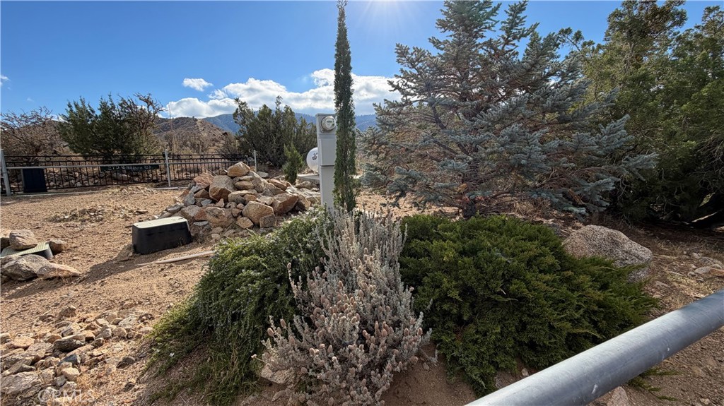 275 Canyon Road Pinon Hills, CA 92372 - Photo 67 of 68 a view of a houses with a yard