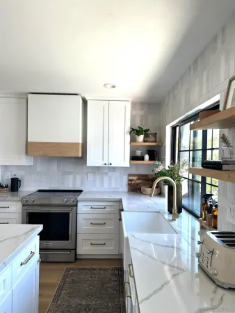 a kitchen with a stove and a white cabinets