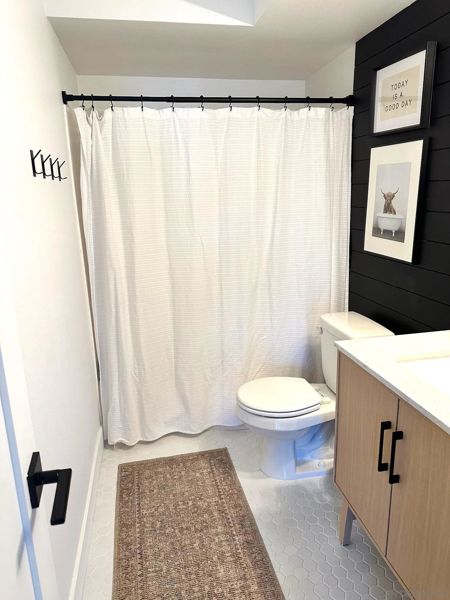 14240 Kendra Way Poway, CA 92064 - Photo 26 of 34 a white toilet sitting next to a shower curtain